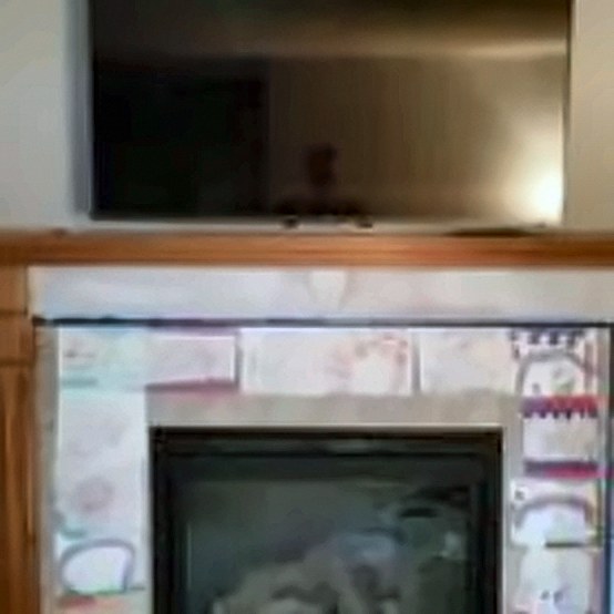 TV over a tiled fireplace