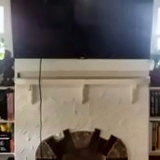 TV over a painted brick fireplace